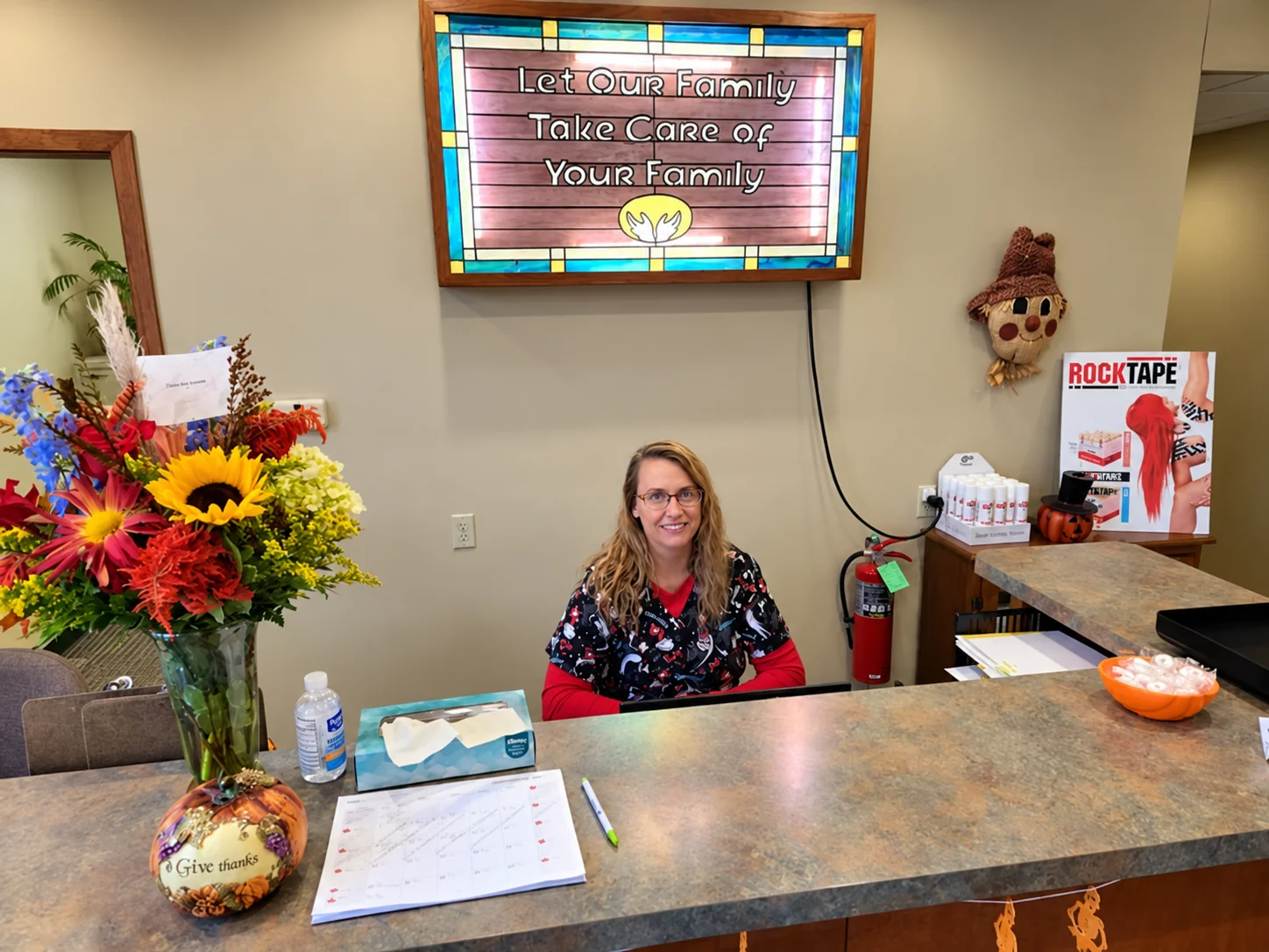 A friendly team member welcomes patients at the front desk