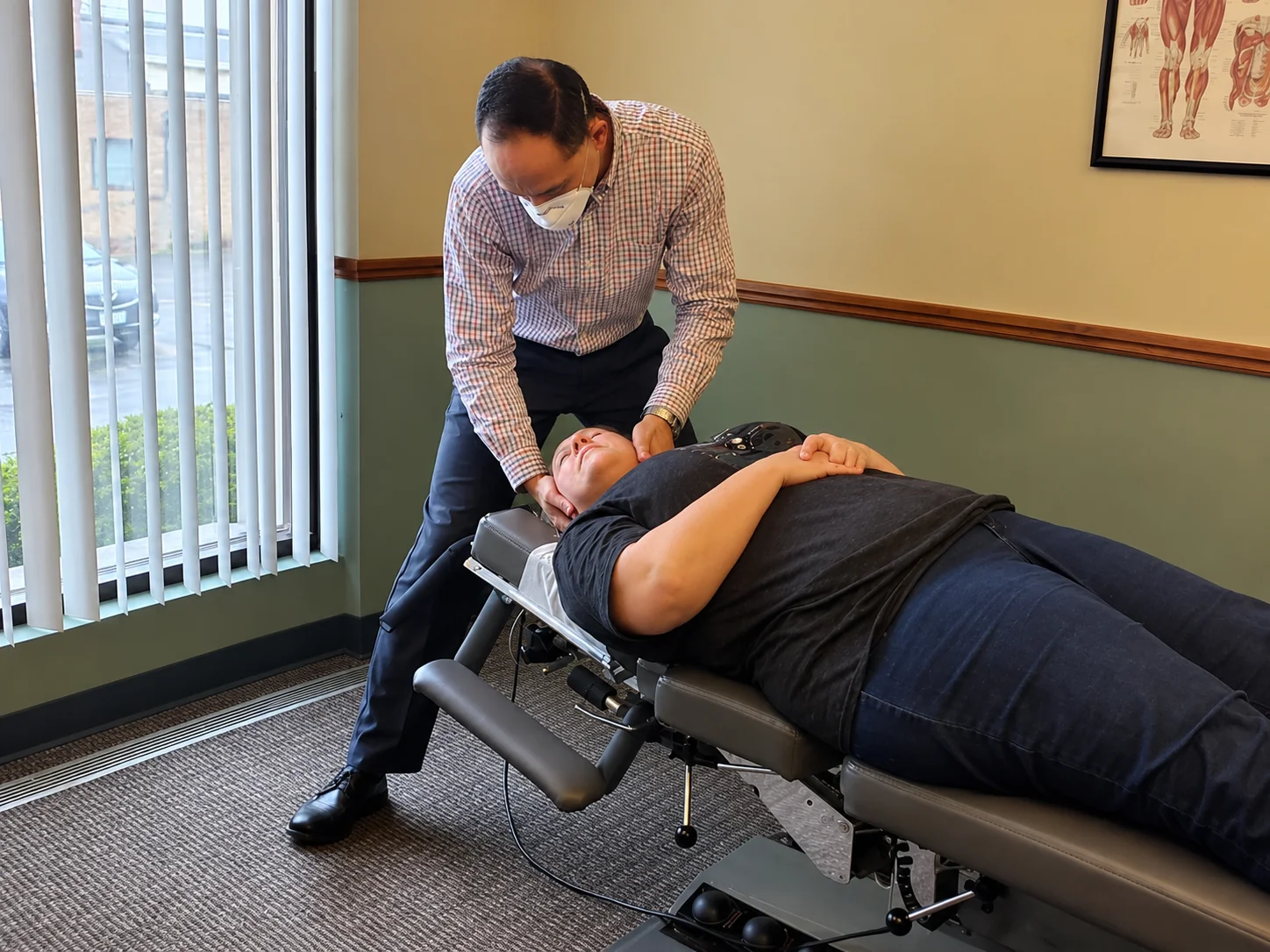 A chiropractor provides hands-on care to a patient in the clinic